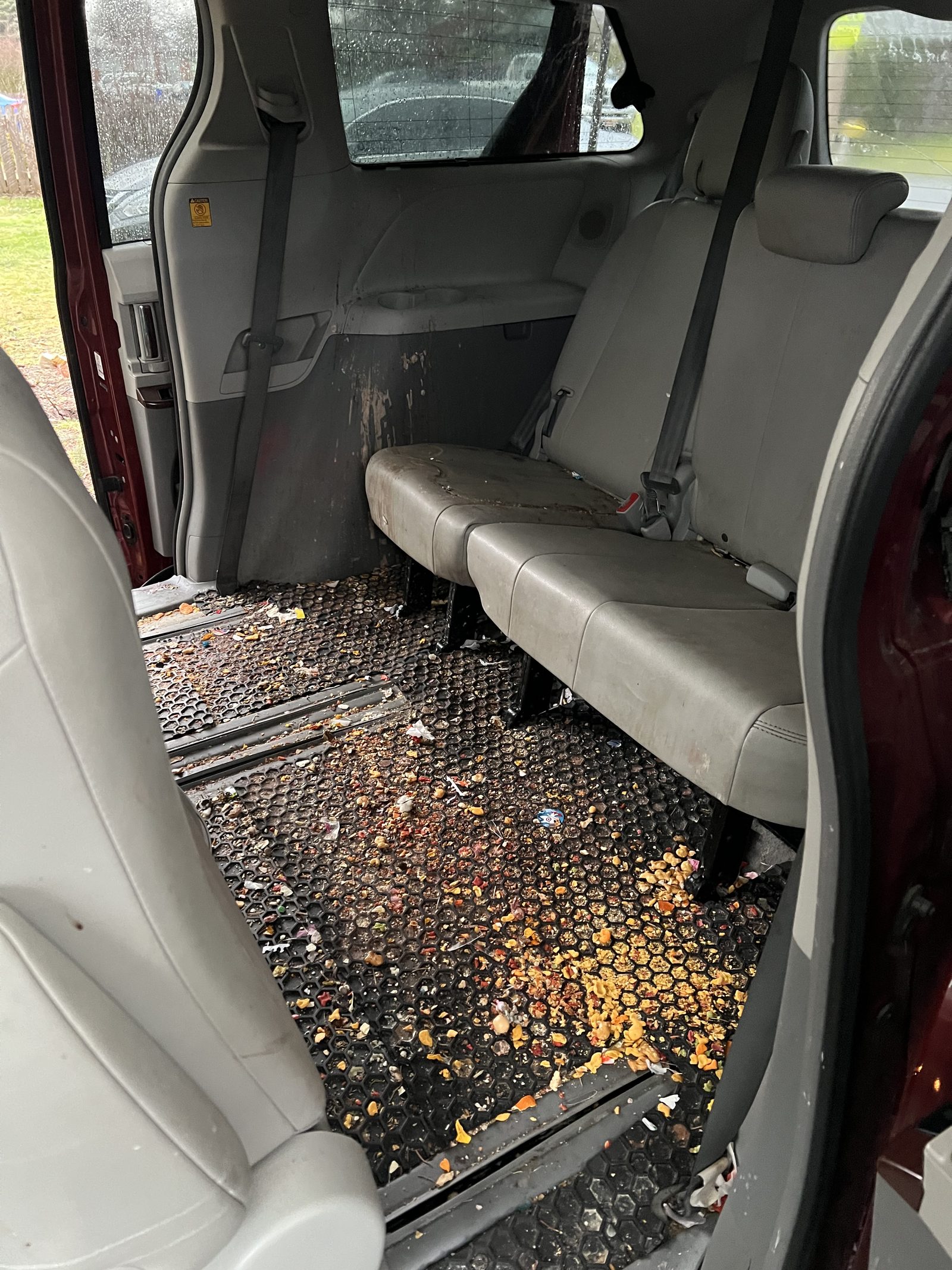 Minivan floor covered in cereal and debris